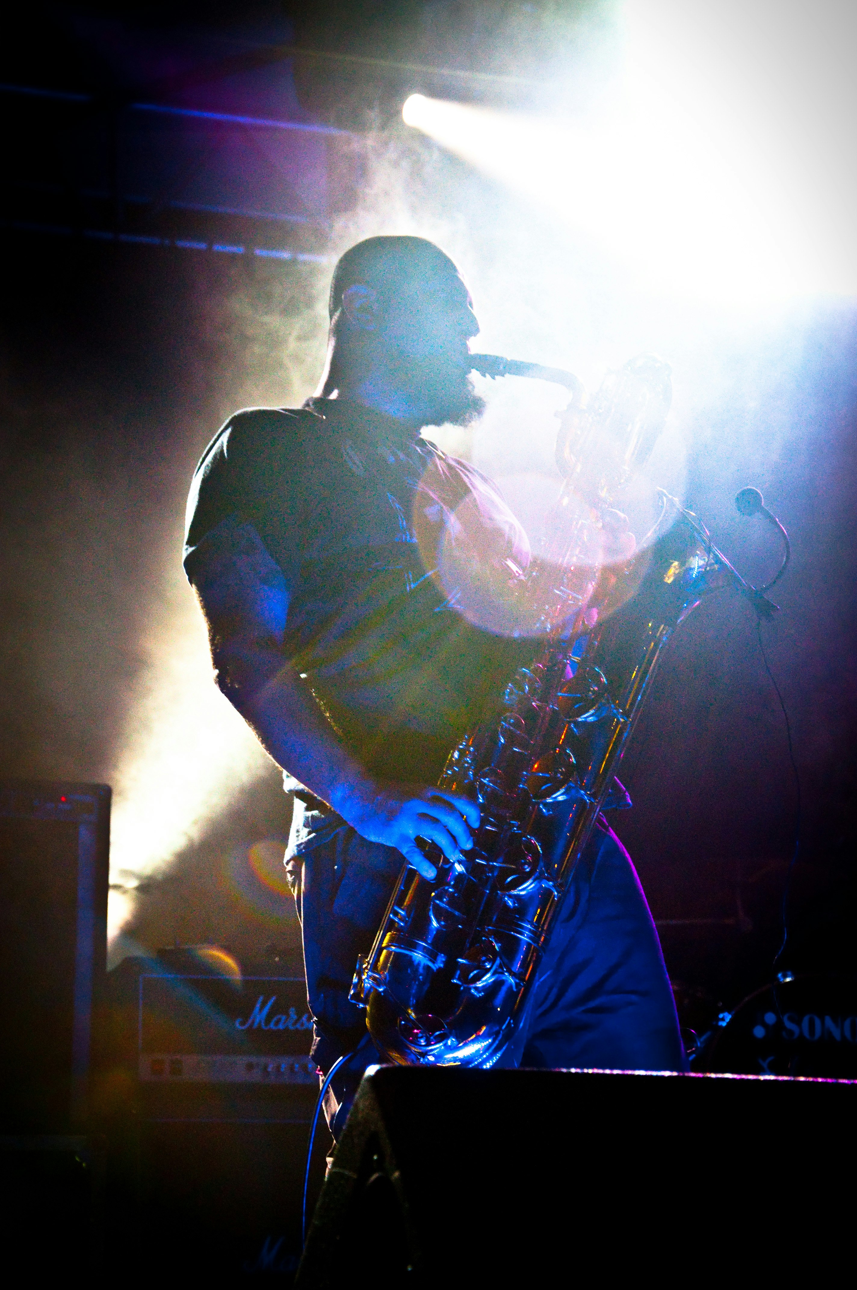 man in black shirt playing saxophone